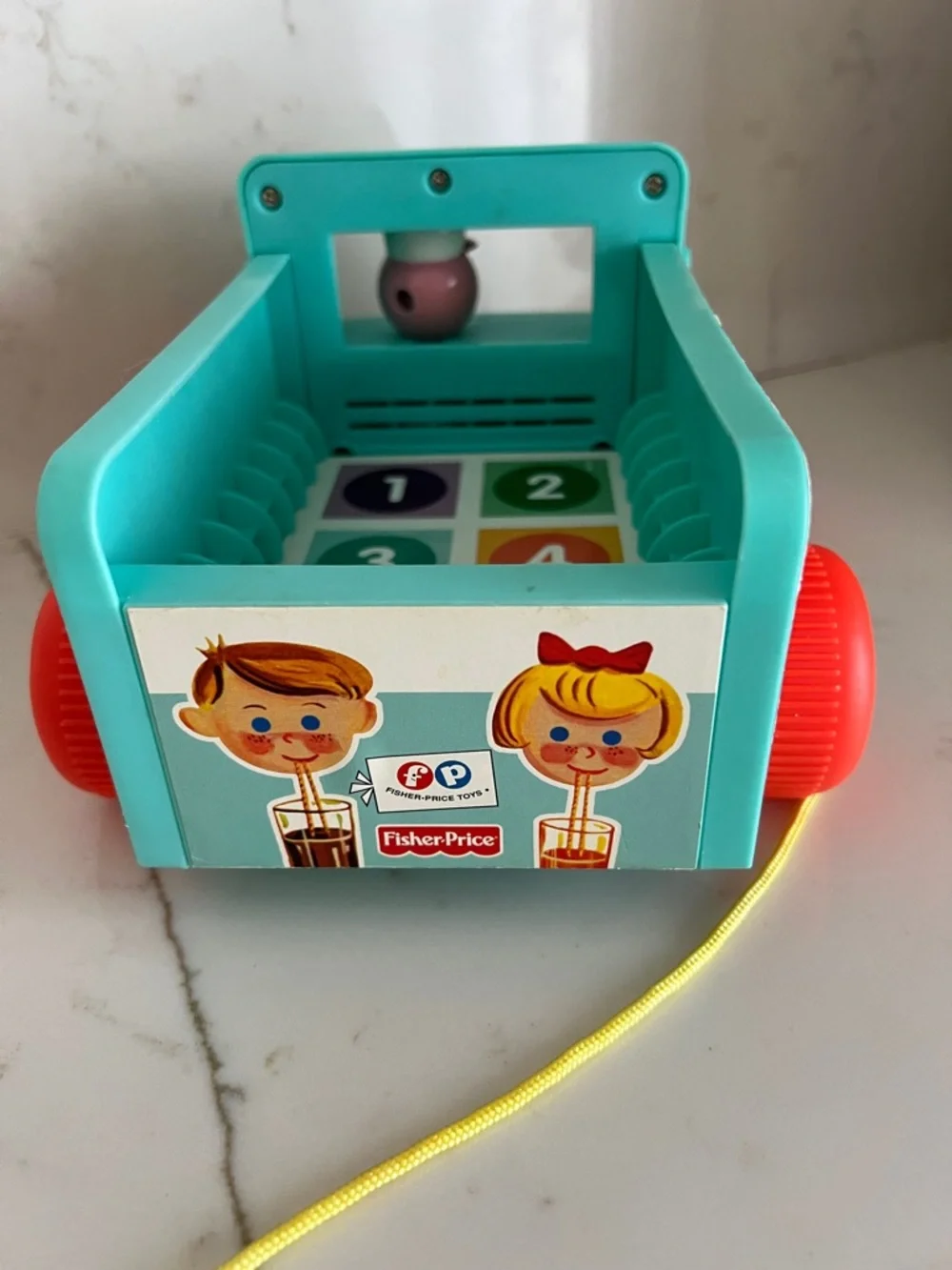 Fisher-Price Teal Milk Wagon Pull Toy with Bright Orange Wheels